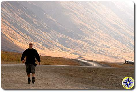 man hiking haul road