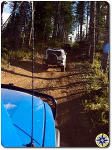 three fj cruiser hill climb in woods