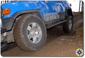 close up fj cruiser lifting rear wheel 4x4 trail