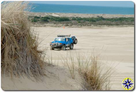 fj cruiser sitting in sand dunes