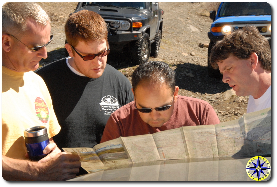 men reading road map