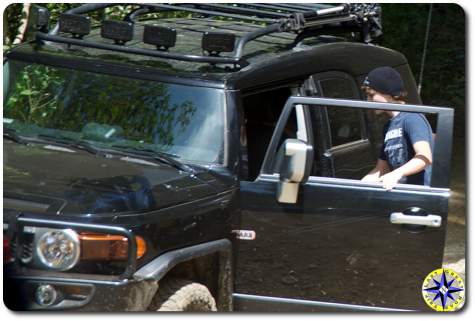 young man getting into black fj cruiser