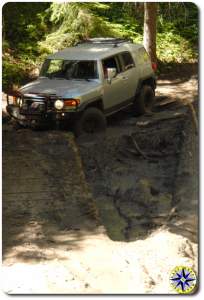 silver fj cruiser bridge over mud pit