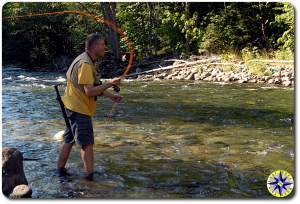 man fly fishing river