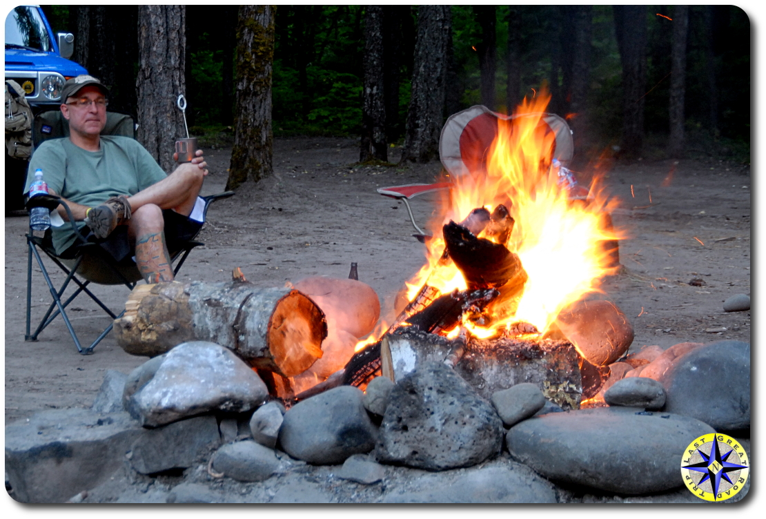 man sitting by camp fire