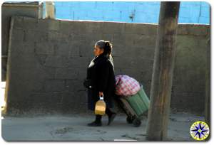 tijauna woman walking by brick wall