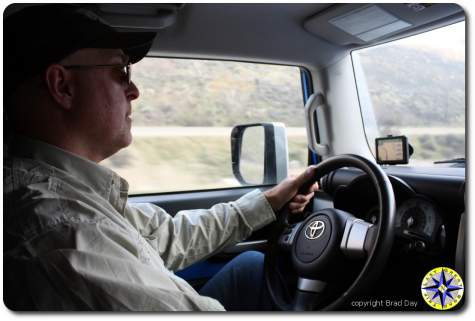 man driving fj cruiser on highway