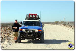 man fj cruiser side of dirt road baja mexico