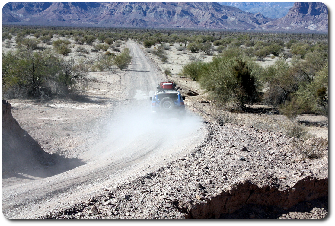 fj cruiser driving away baja road