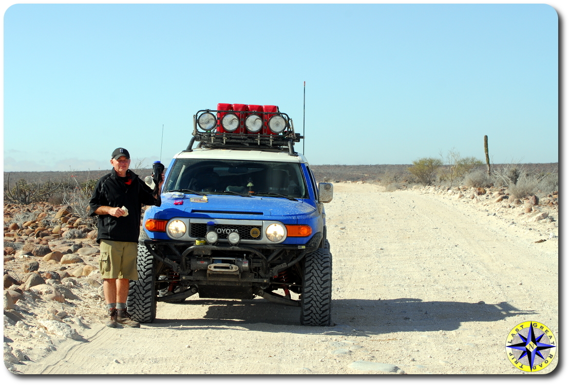 man fj cruiser side of dirt road baja mexico