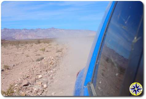 dusty road behind fj cruiser