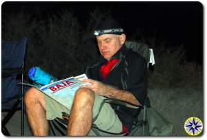 man in camp chair studying baja map