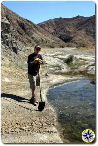 man leaning on shovel baja mexico