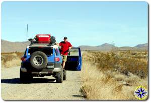 man standing on fj cruiser baja mexico