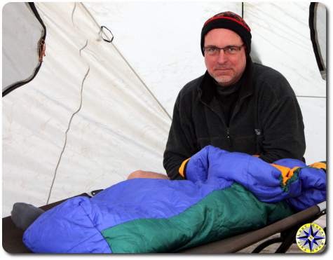 man in sleeping bag camping