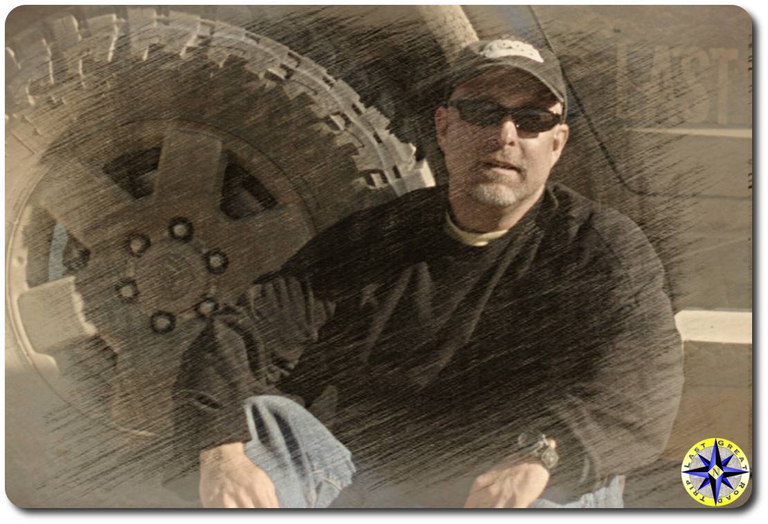 paul sketch man sitting next to truck tire