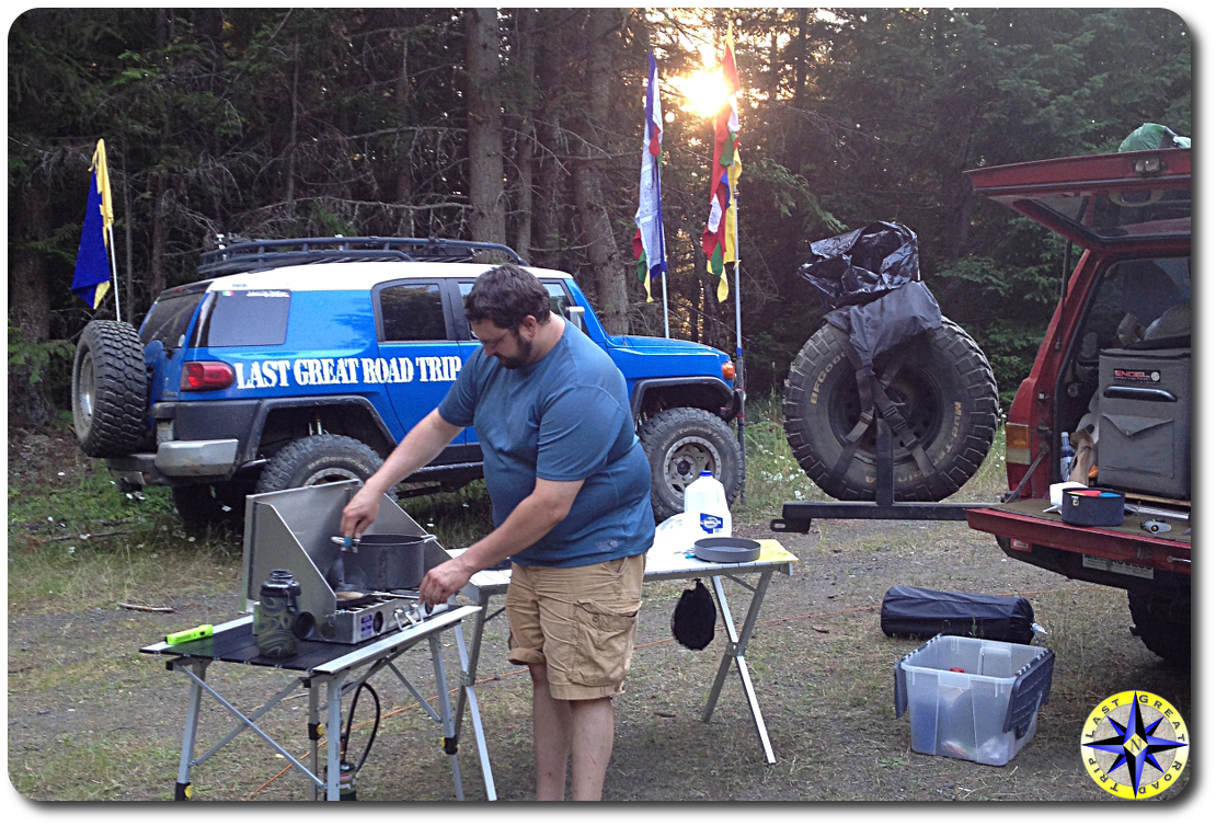 man cooking camp stove