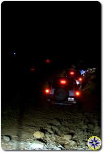 toyota fj cruisers tail lights on 4x4 trail at night