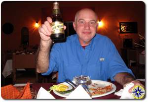 man toasting with negra modelo beer
