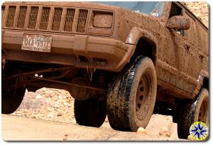 muddy jeep on incline