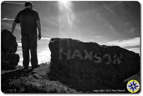 man standing next to hanson rock