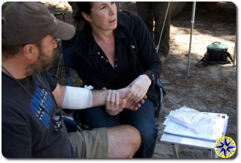 woman taking injured man pulse